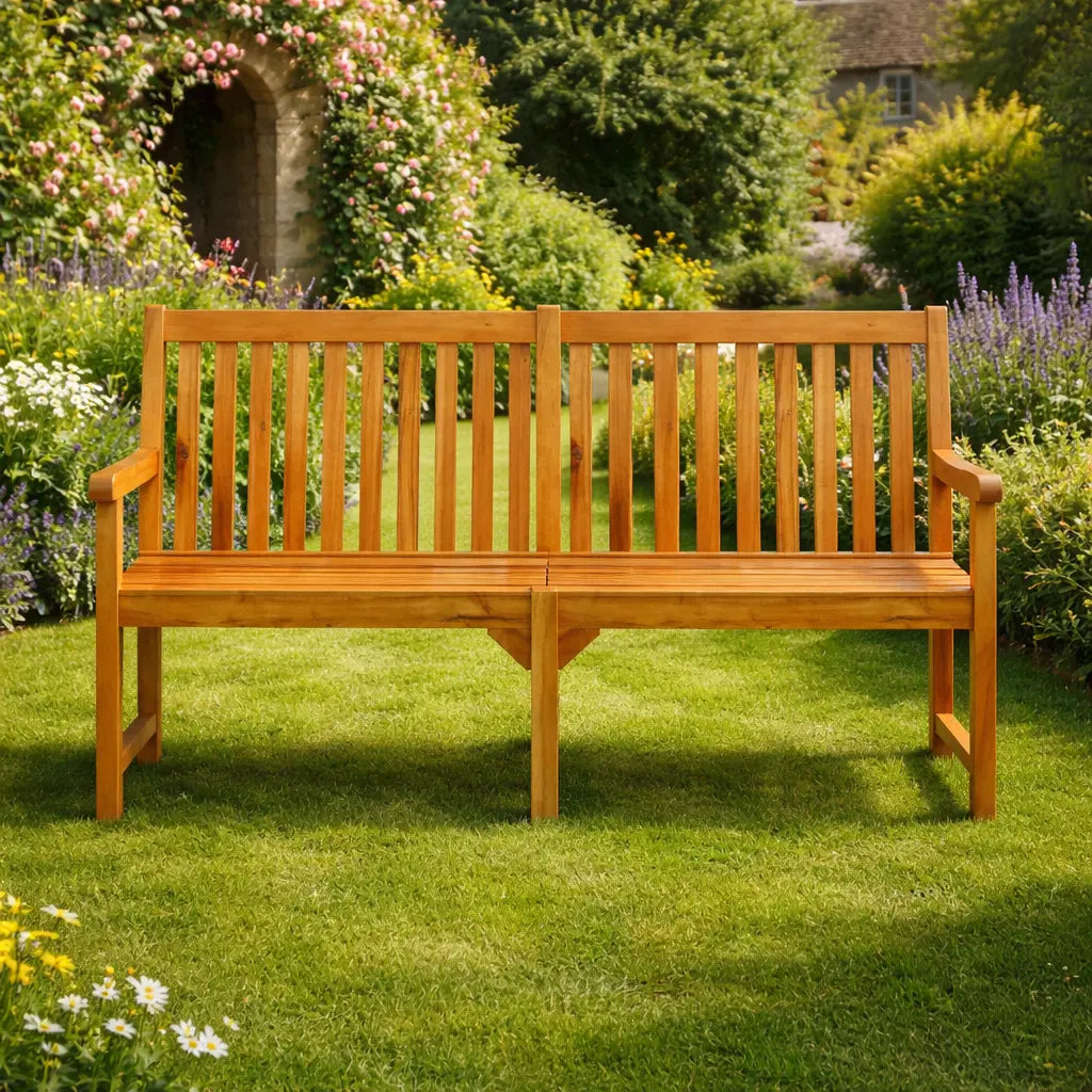 Front view of an extra-wide wooden garden bench on a green lawn, with a floral arch and summer garden background